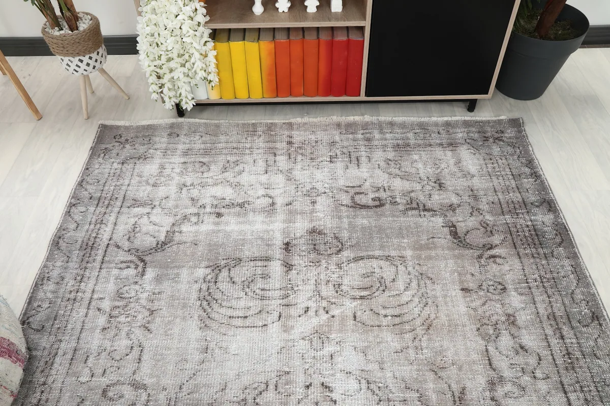 Angled view of the rug on a light floor, showing its subtle color variations