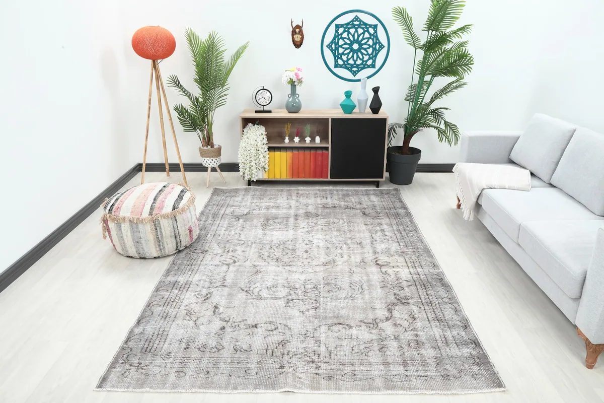 Vintage gray rug displayed in a modern living room setting with light furniture
