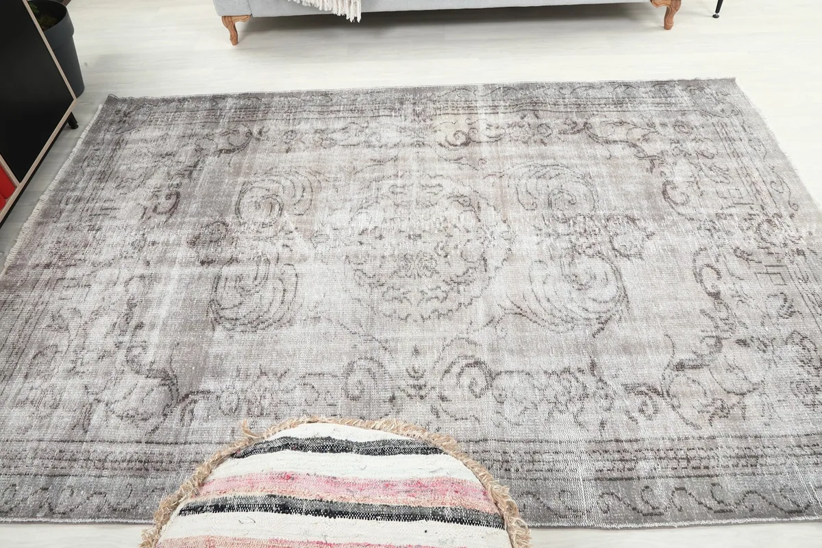 View of the gray rug from a low angle within a living space, highlighting its placement