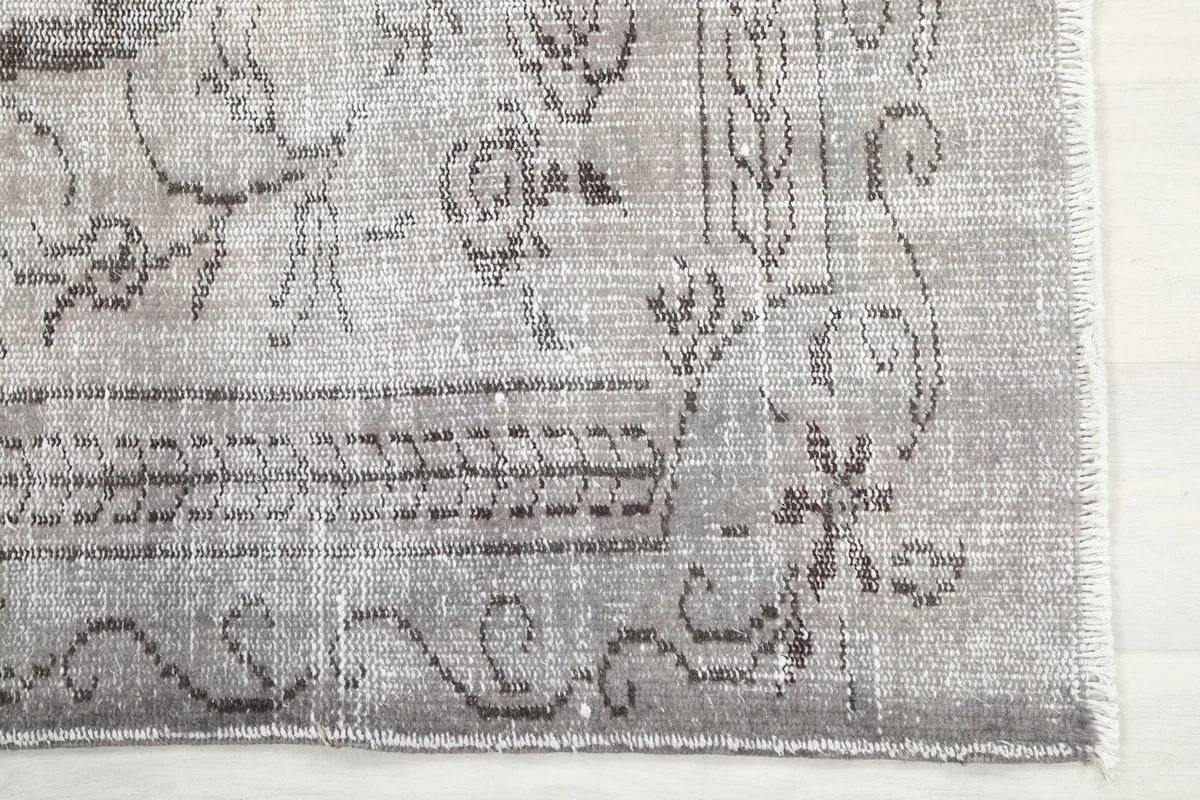 Close-up of the rug's border pattern and corner with visible fringe