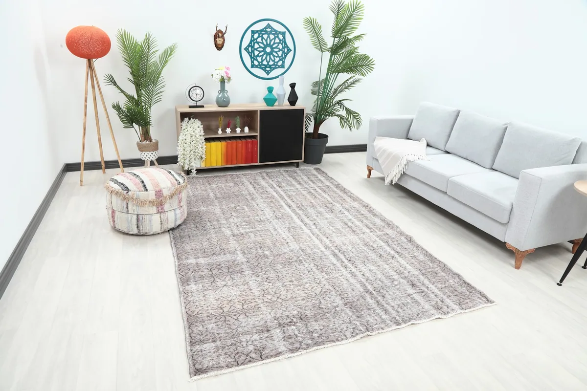 Overhead angle of the 6x9 vintage rug placed in a living room, showing its scale relative to furniture.