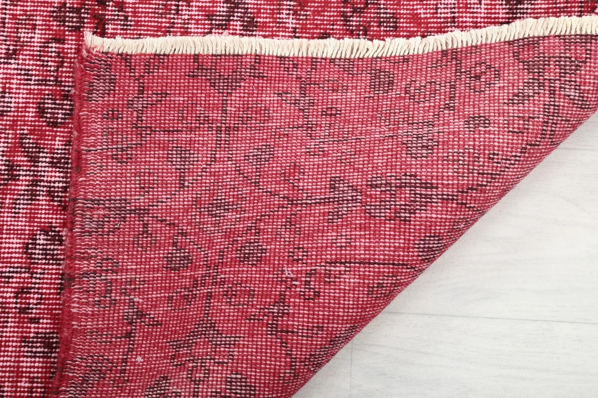 Close-up of the rug's back, showing the hand-knotted construction and cotton foundation.