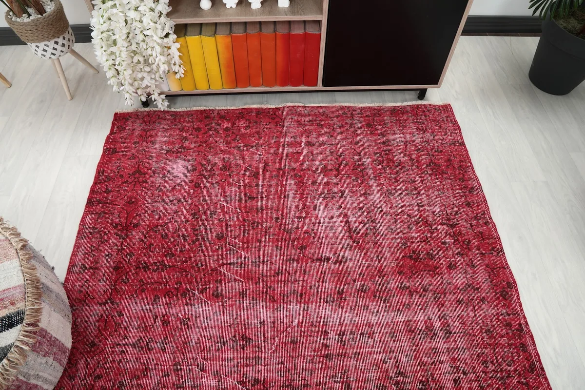 Overhead perspective of the rose rug, showcasing its rectangular shape and overall distressed appearance.