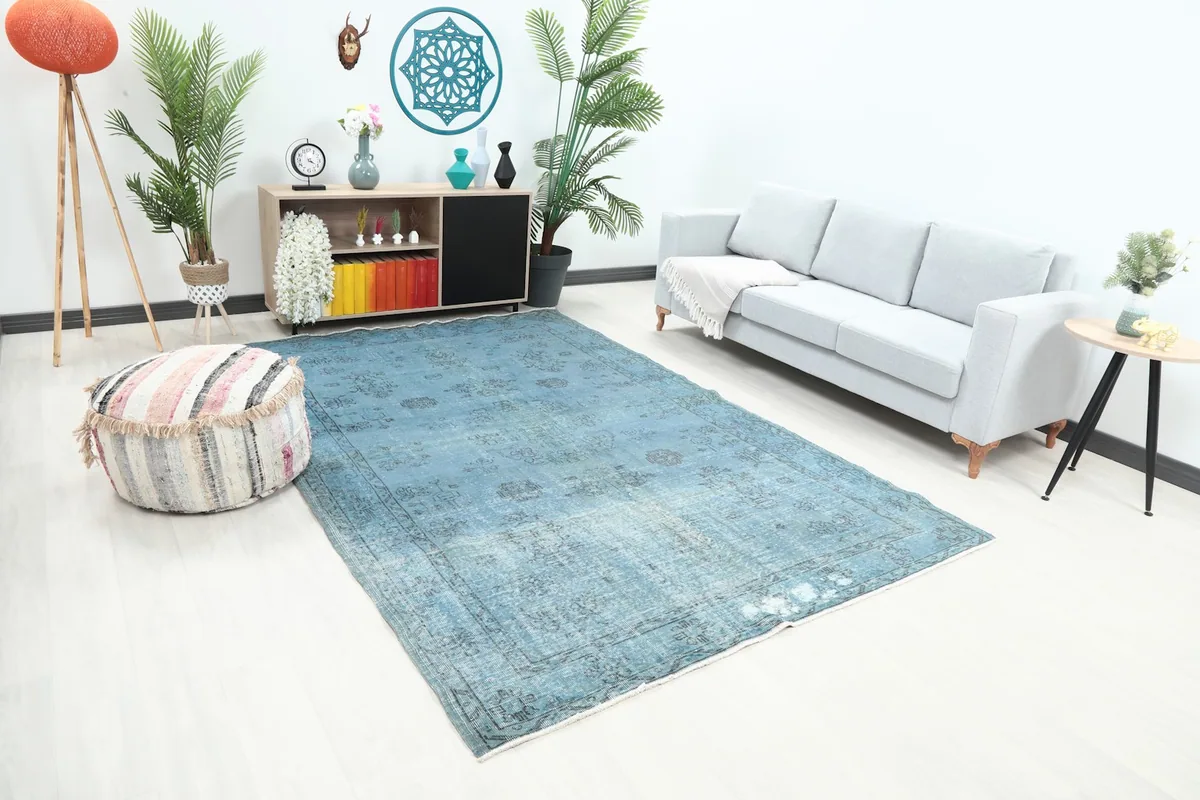 Angle view of the blue geometric rug in a living space, showing its placement relative to furniture