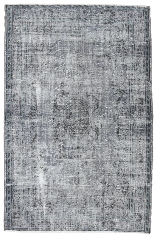 Full overhead view of the charcoal gray distressed vintage Anatolian rug on a white background