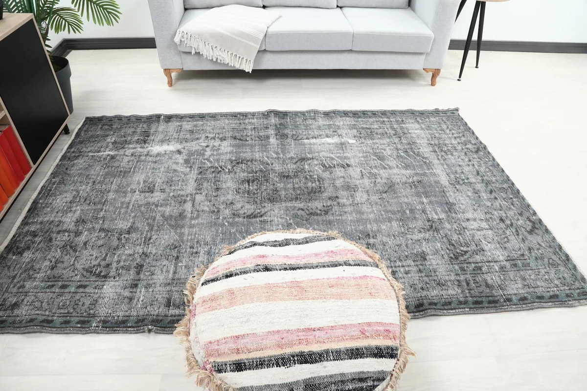 Full room view of the vintage gray rug, emphasizing its medium size and rectangular shape