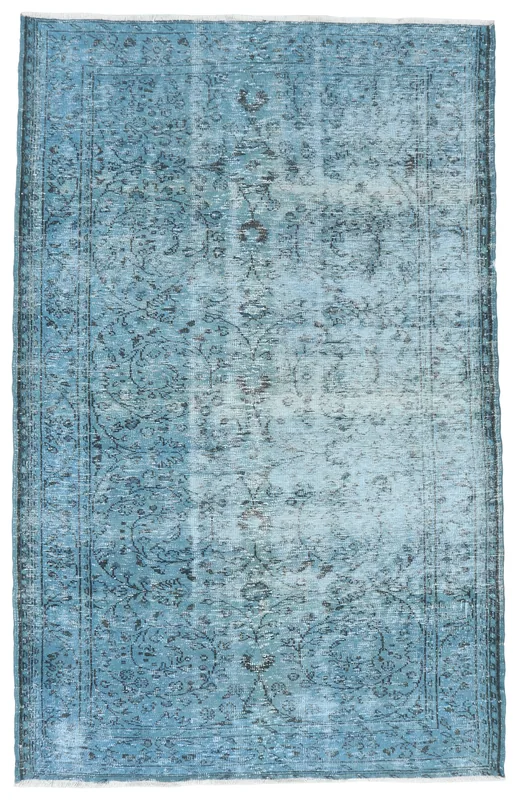 Full top view of the 5'10" x 9'4" faded blue vintage Anatolian rug with a central medallion.