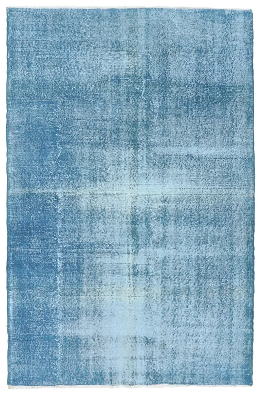 Full overhead view of the blue distressed vintage Anatolian area rug on a white background.
