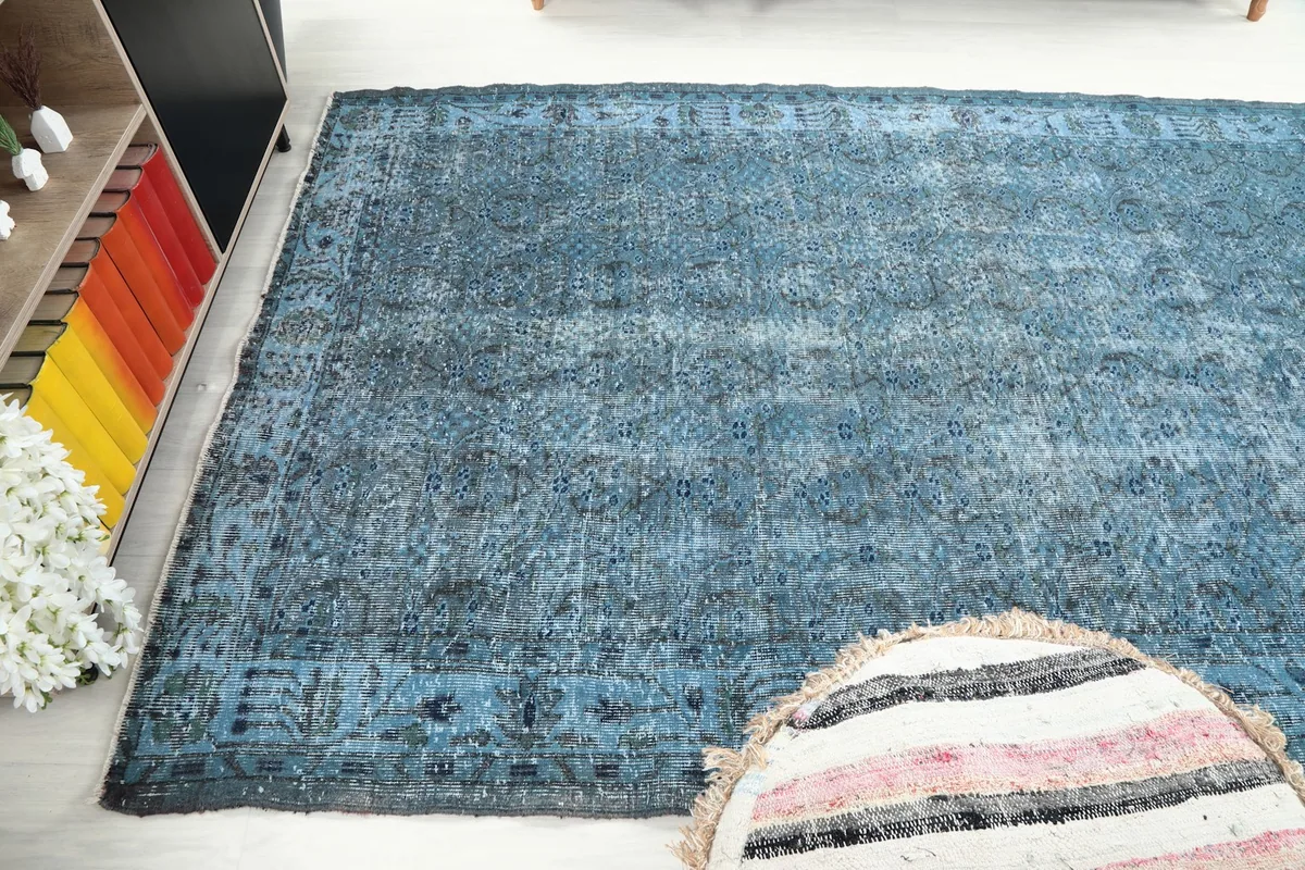 Diagonal view of the rug's surface, capturing the distressed texture and color variations