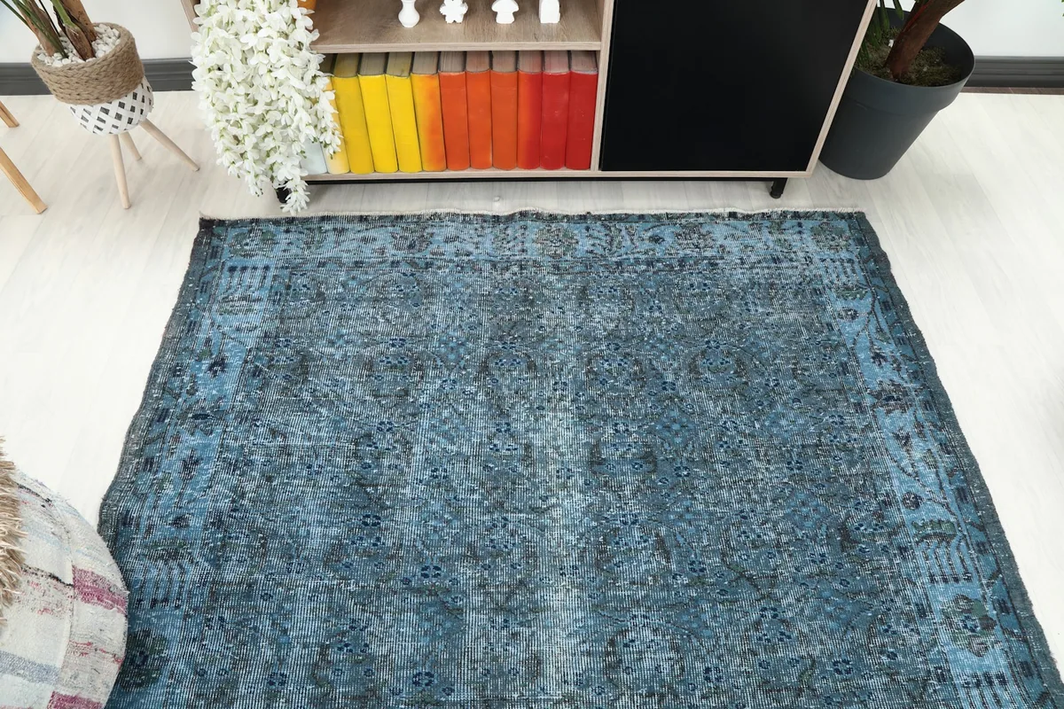 Overhead perspective of the blue rug in a room, showing its placement relative to furniture