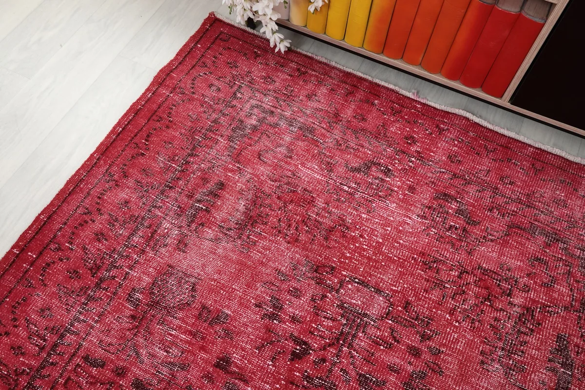 Angled view of the rug's top corner, showing color and pattern fading
