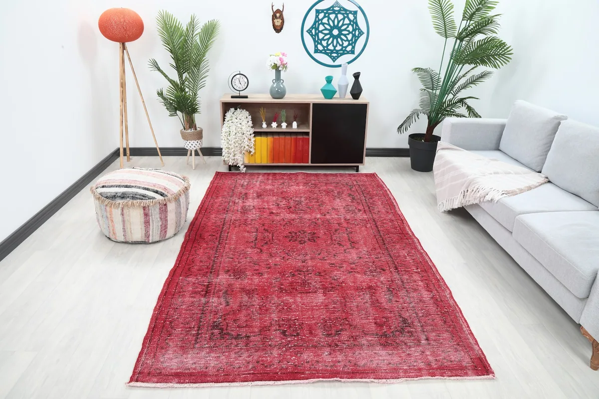 Vintage red and charcoal rug displayed in a modern living room setting