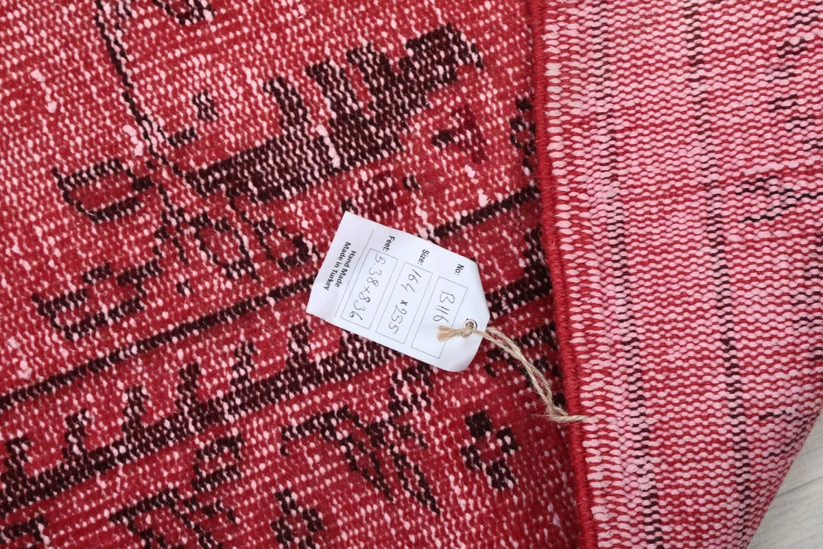 Close-up of the rug's underside with a product tag showing details