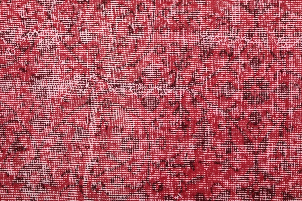 Close-up of the hand-knotted wool pile, revealing the intricate weave and characteristic wear.