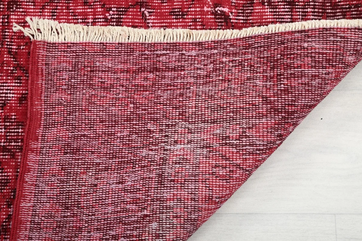 Detailed view of the rug's underside and fringe, illustrating the hand-knotted construction.