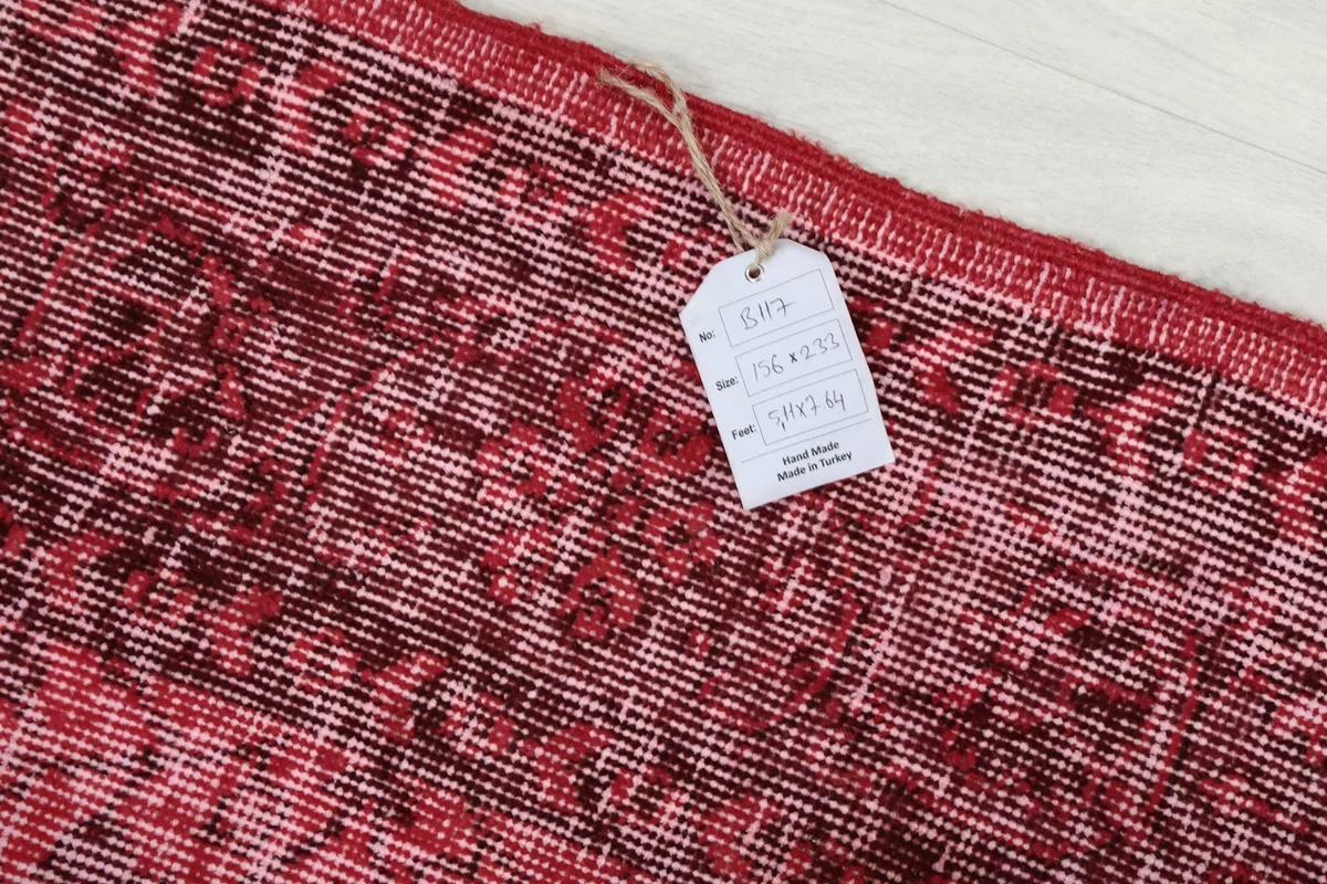 Close-up of the product tag attached to the vintage Anatolian rug, displaying its origin and material.