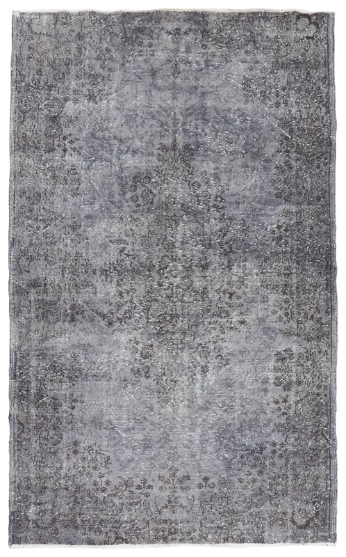 Full overhead view of the gray vintage Anatolian rug on a white background