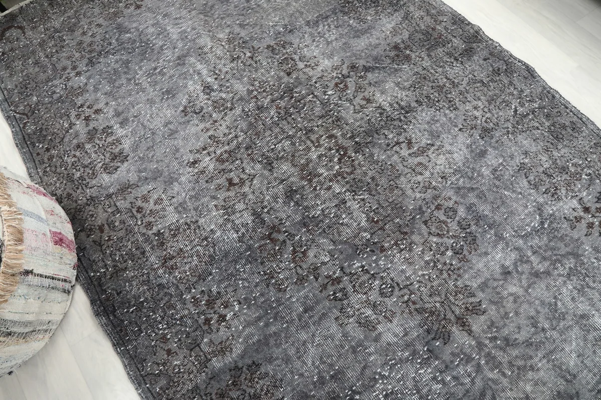 Overhead angle shot of the gray vintage rug, capturing its overall distressed look