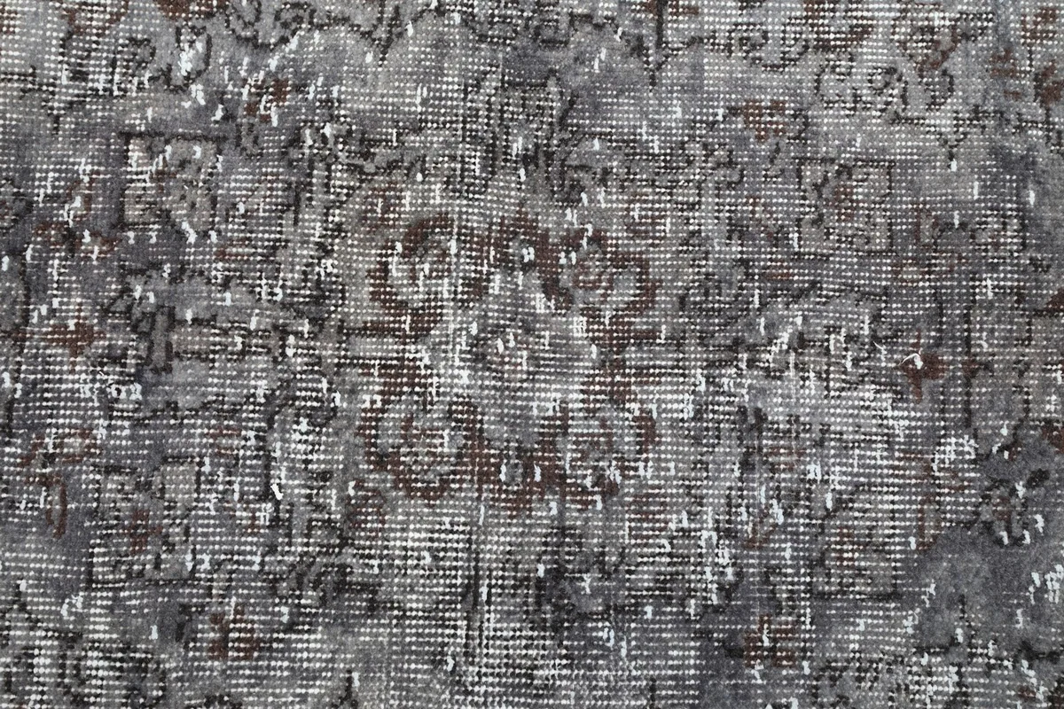 Close-up of the low pile and visible knotting of the vintage wool rug