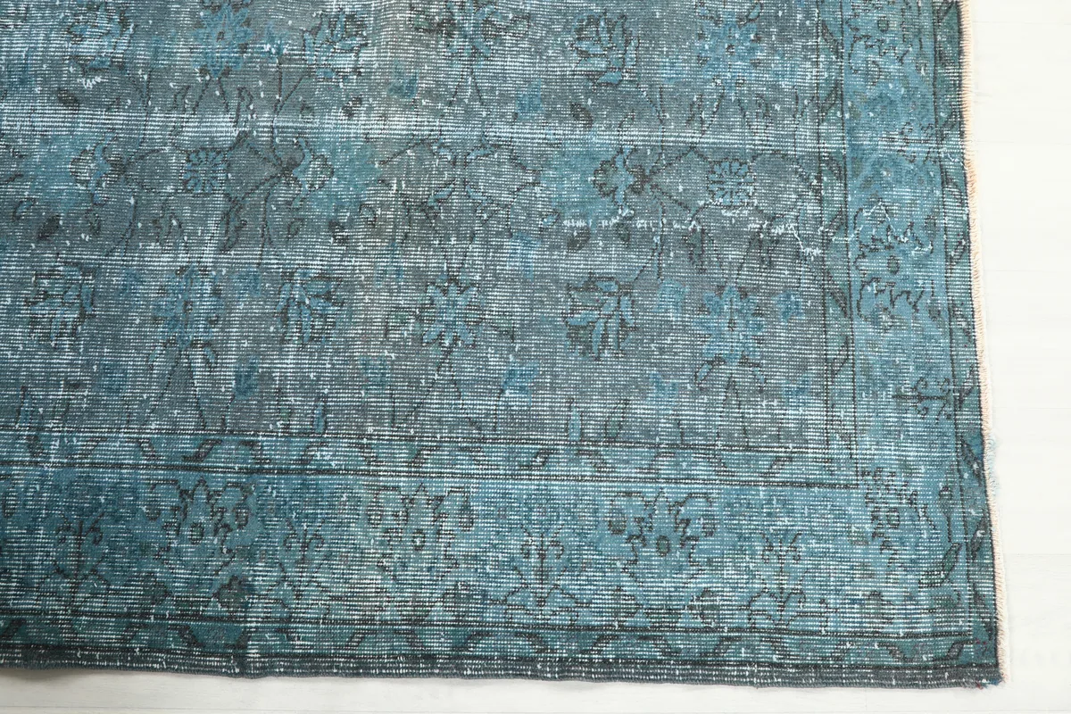 Detail of the Blue Gray Faded Floral Anatolian Rug's surface, showing the faded floral and geometric motifs.