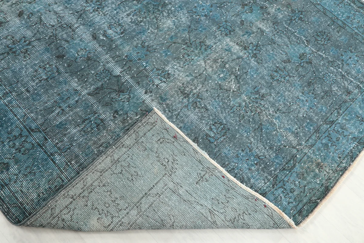 Underside corner of the Blue Gray Faded Floral Anatolian Rug, showing the hand-knotted cotton foundation and weave.