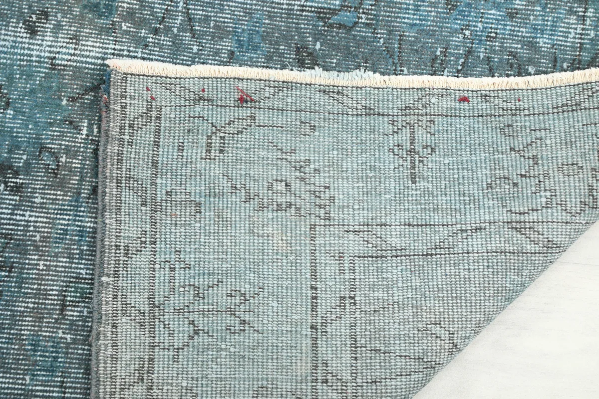 Detailed view of the back of the Blue Gray Faded Floral Anatolian Rug, revealing the intricate knotting and craftsmanship.