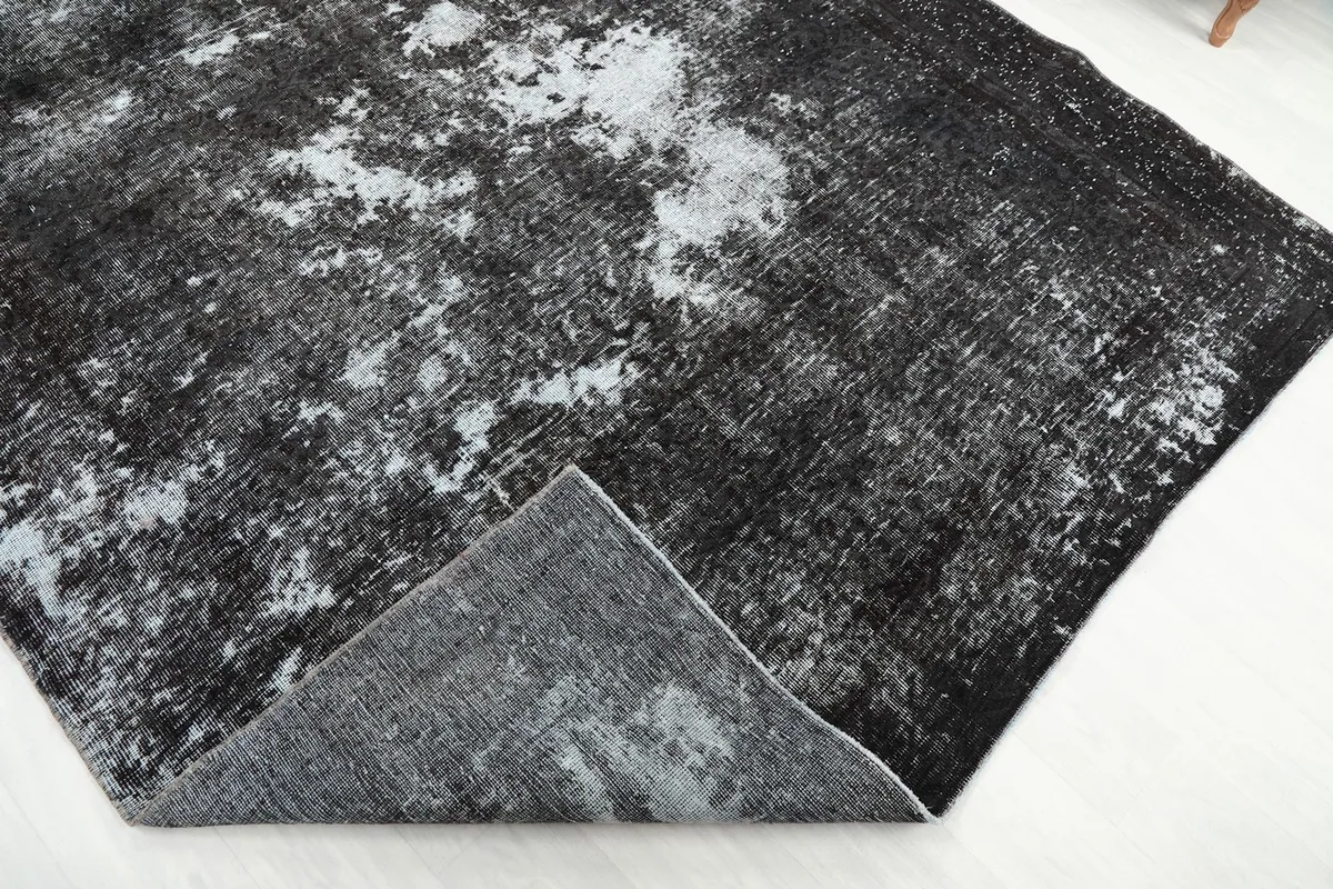 View of the rug's underside, revealing the hand-knotted cotton foundation