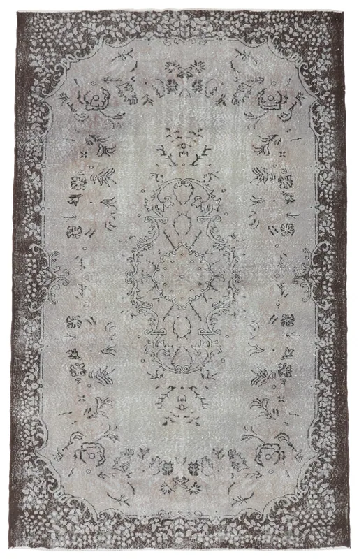 Full top view of the gray and brown vintage Anatolian area rug on a white background