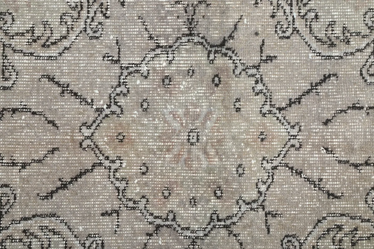 Macro shot of the intricate hand-knotted details within the central medallion of the rug