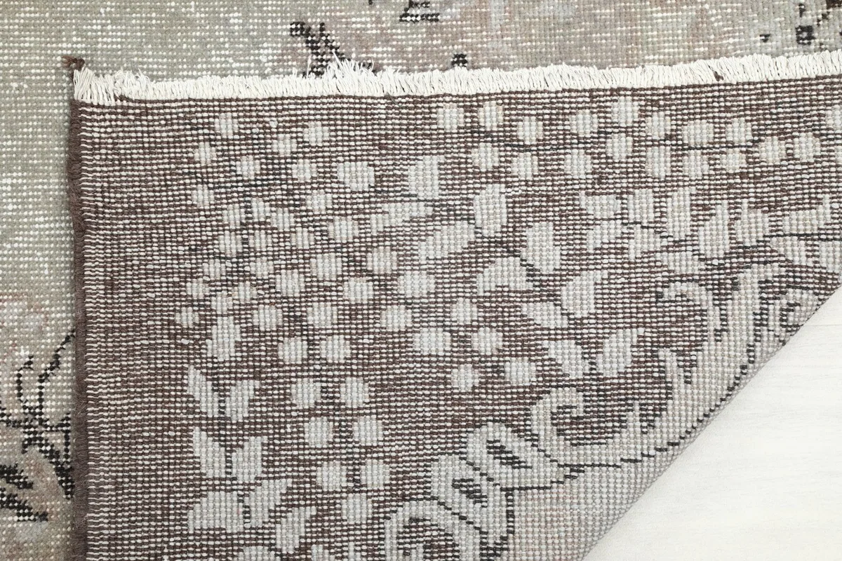 Close-up of the back of the rug, revealing the tightly woven hand-knotted construction