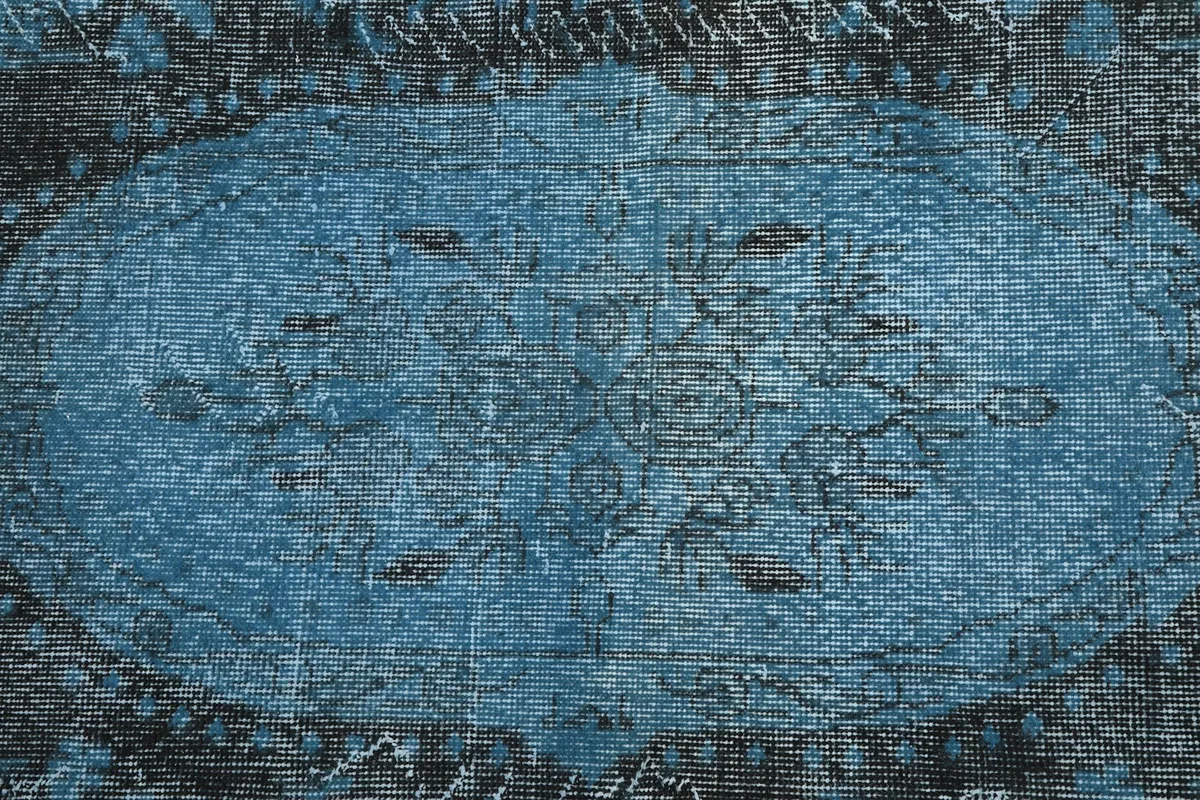 Overhead detail of the distressed central medallion and faded blue and charcoal colors