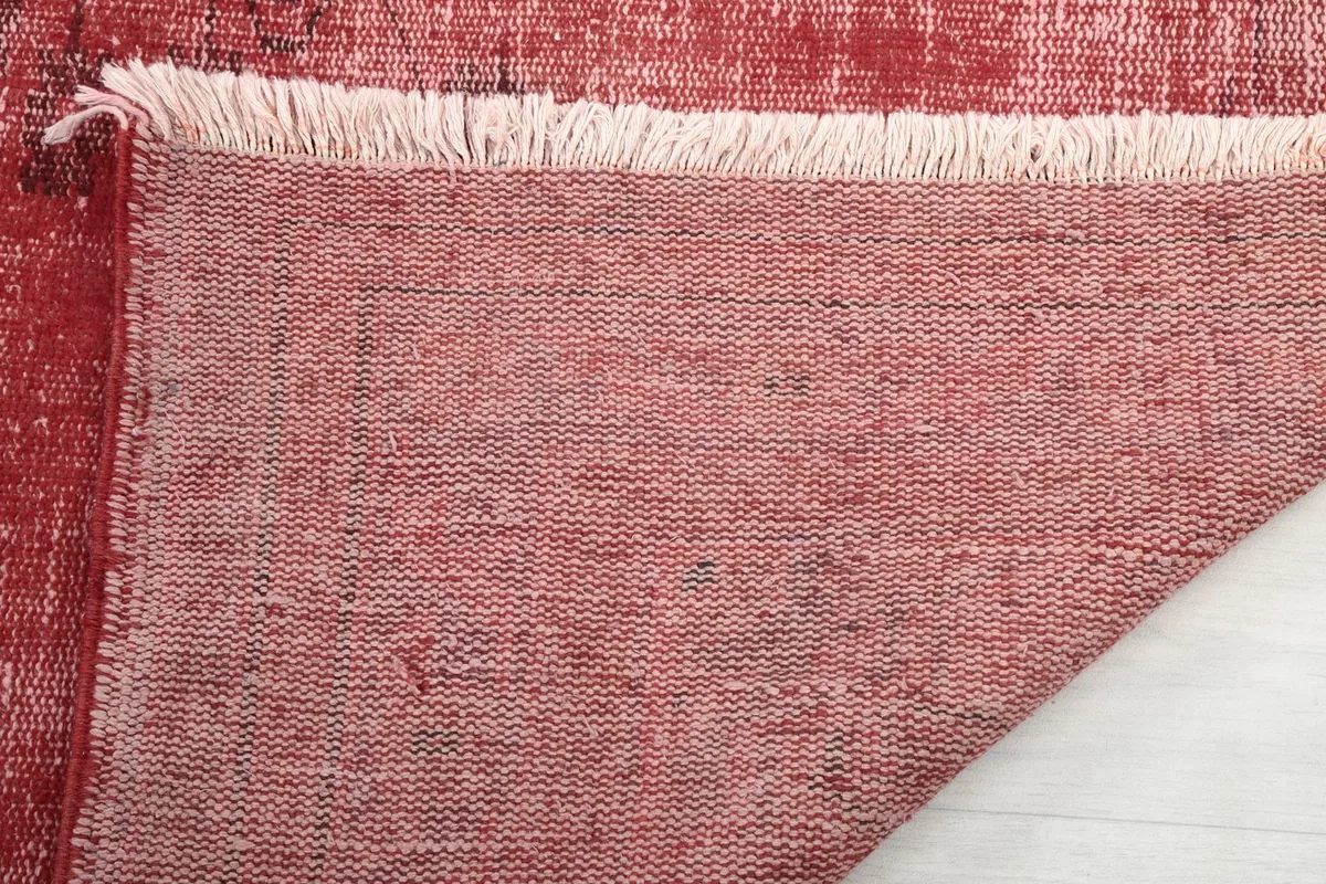Close-up of the rug's back and fringe, demonstrating the hand-knotted craftsmanship