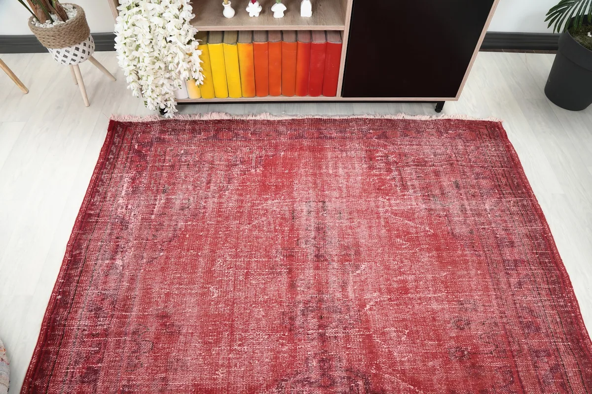 Overhead view of the red area rug, showcasing its full length and width in a room
