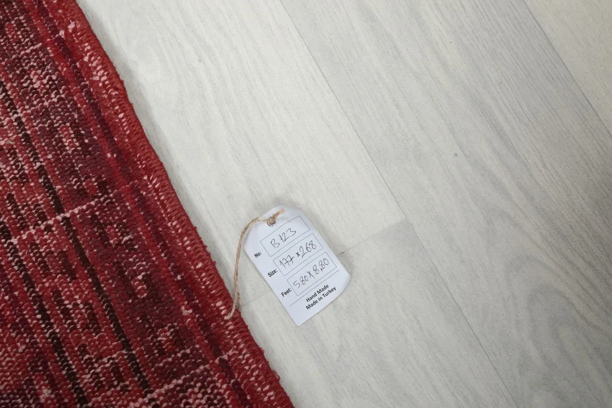 Product tag on the floor next to the rug, showing details and confirming its origin