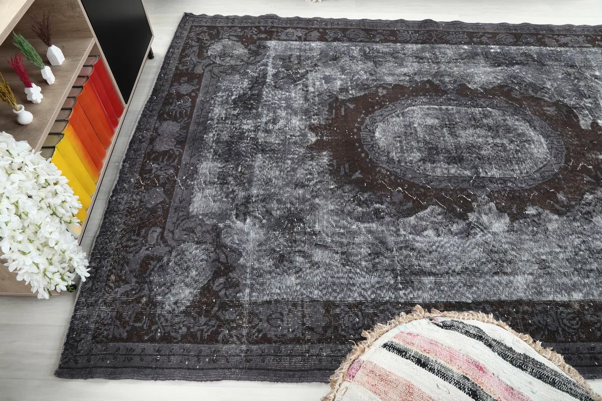 Side angle view of the vintage rug, capturing its texture and color variations