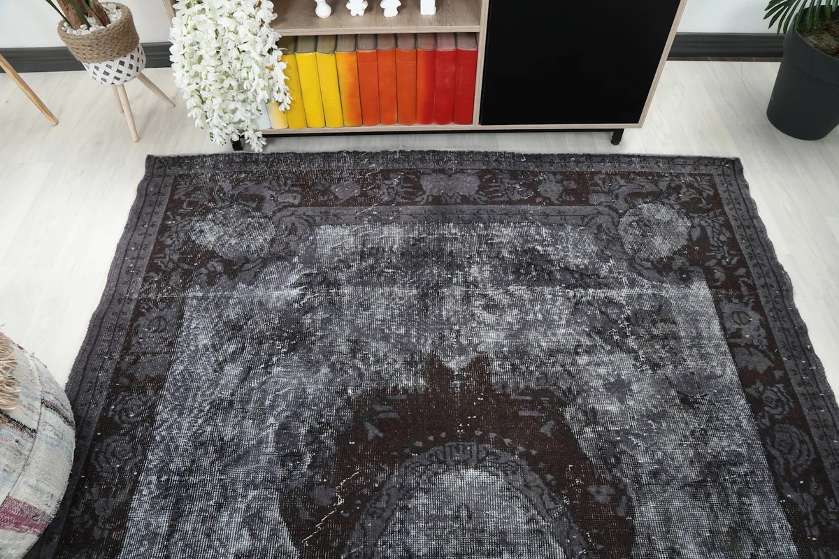 Overhead view focusing on the upper half of the rug, showing the consistent patina