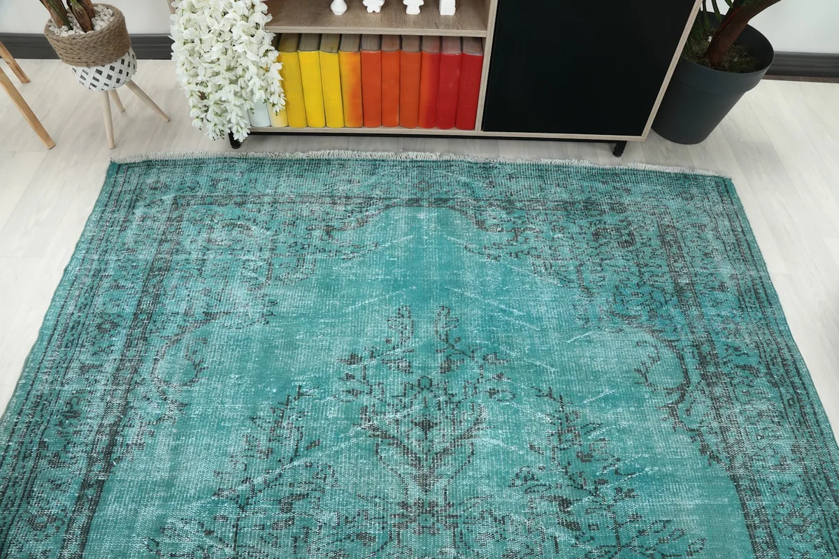 Overhead view of the rug, emphasizing its overall pattern and the blend of blue and charcoal tones.
