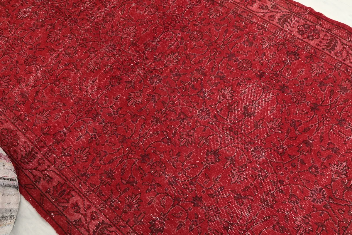 Overhead angle view of the rug, focusing on the central field and its subtle floral motifs.