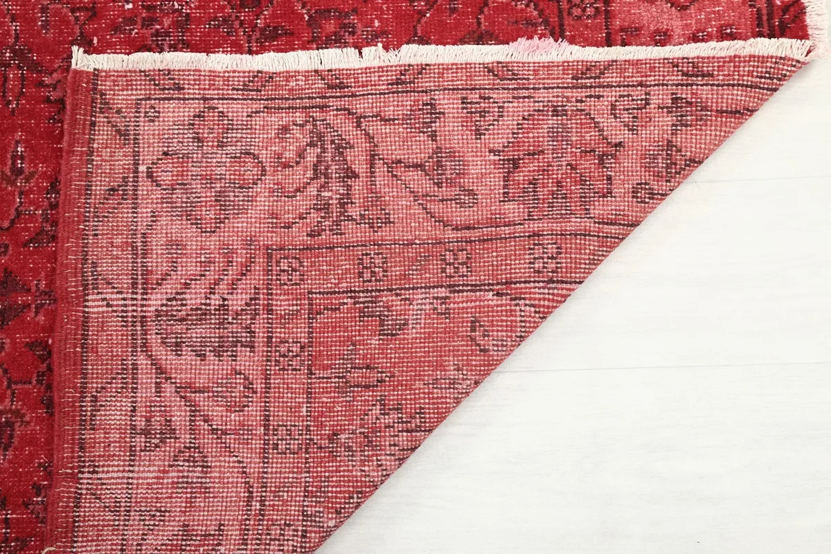 Close-up of the rug's reverse side, showing the tight knotting on the cotton foundation.