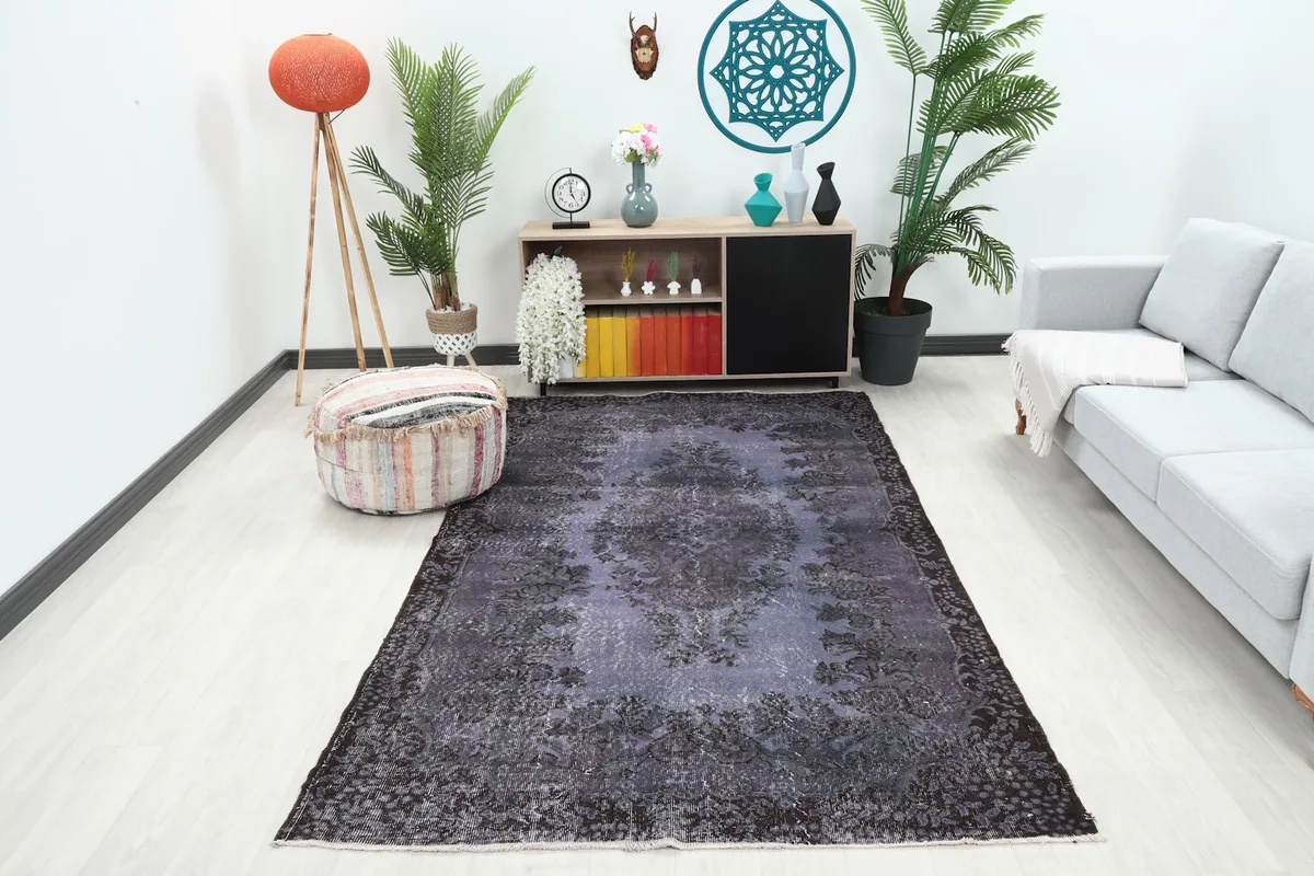 Vintage purple and charcoal area rug in a modern living room setting