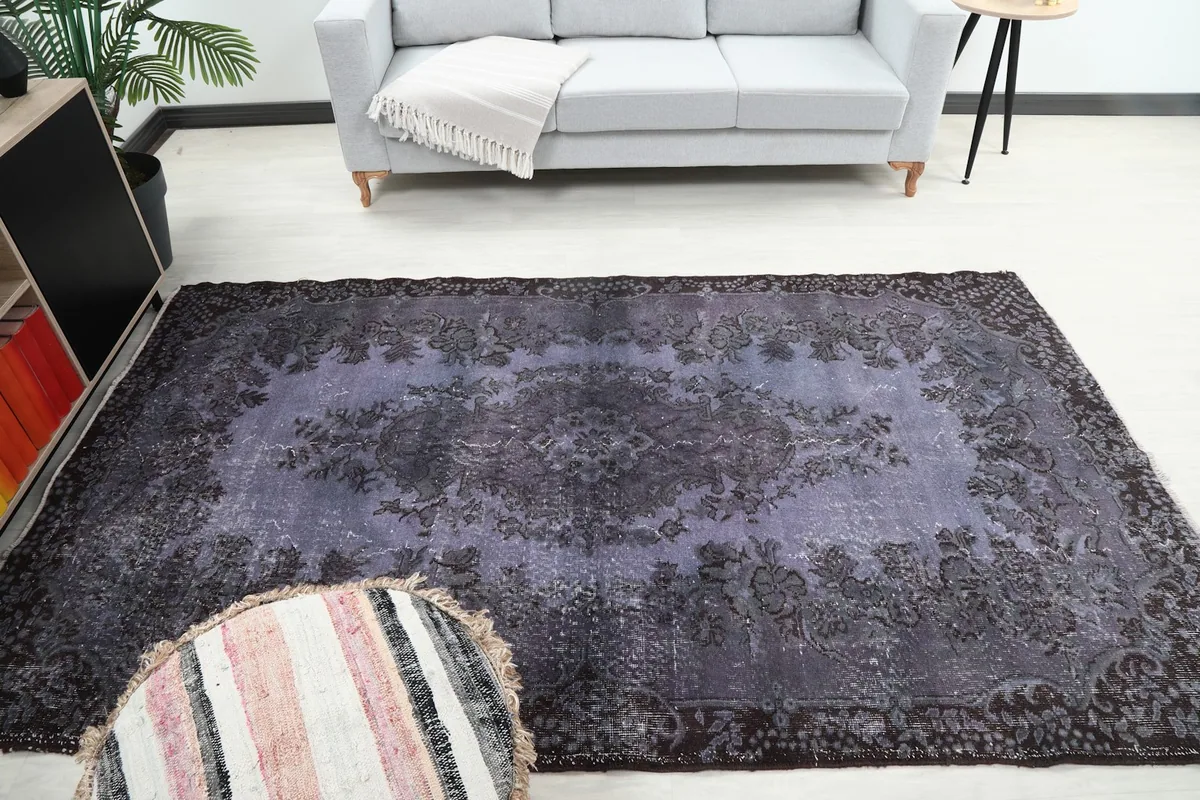 Overhead room shot of the purple floral medallion rug with surrounding decor