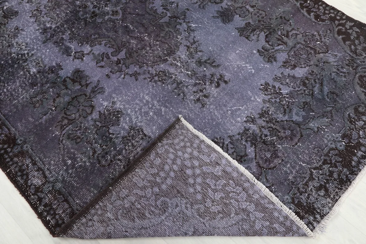 Folded corner showing the reverse side of the hand-knotted wool rug