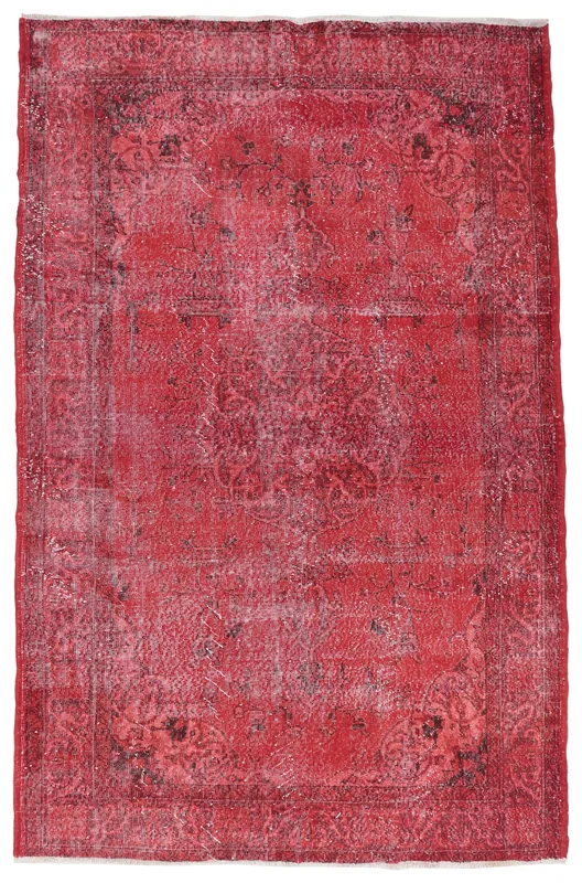 Full overhead view of the red vintage hand-knotted area rug with faded geometric patterns.
