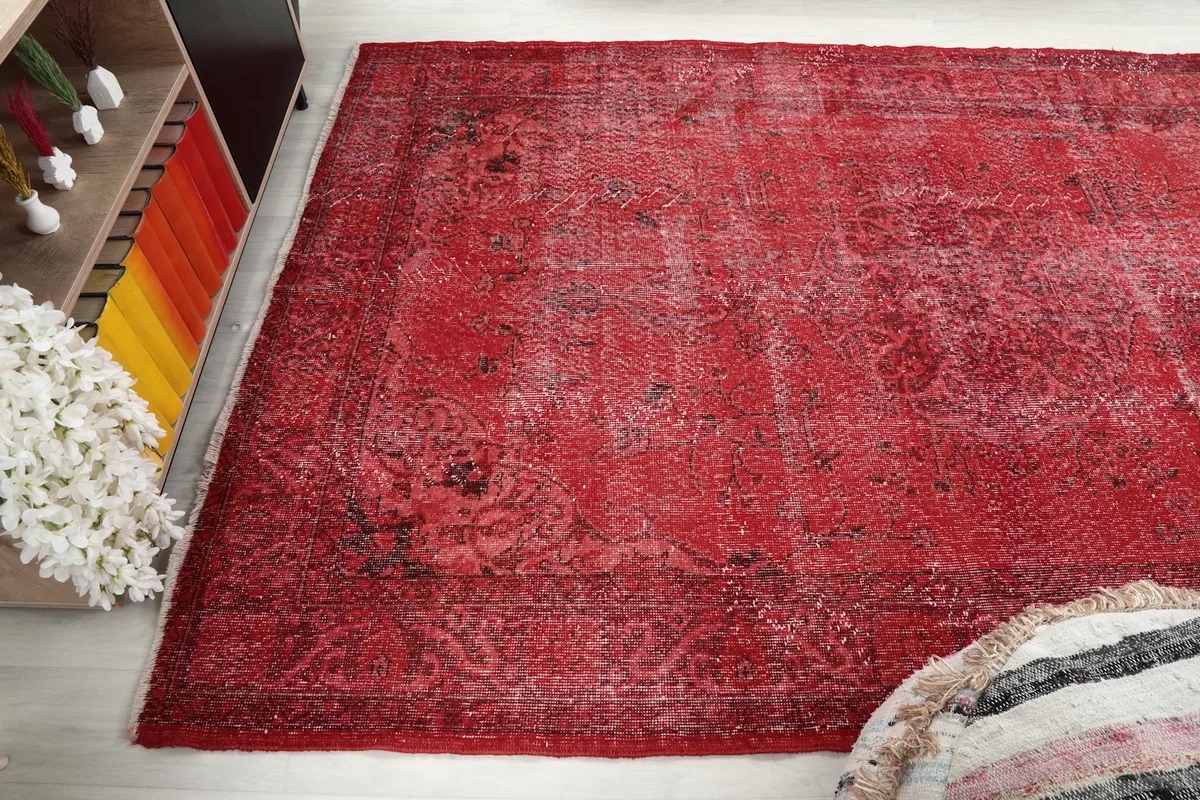 Another angle view of the rug, emphasizing the worn areas and color variations.