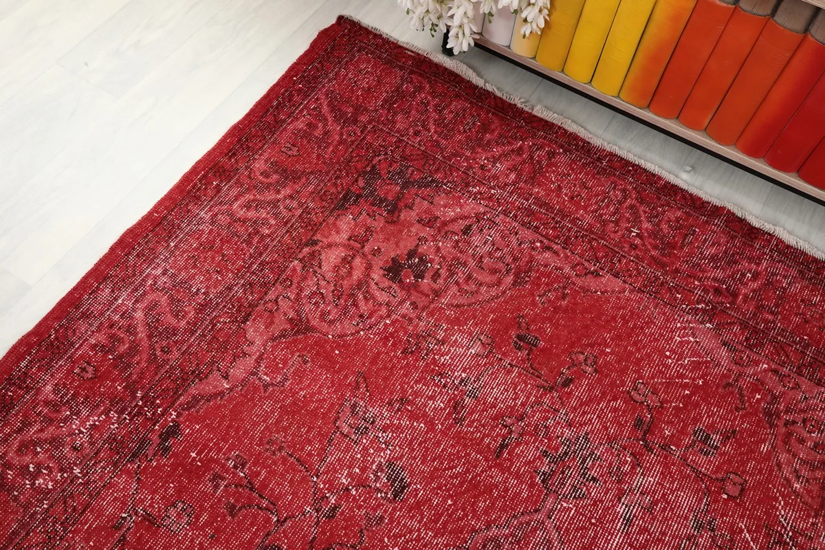Corner detail of the rug, showing the intricate border design and the overall patina.