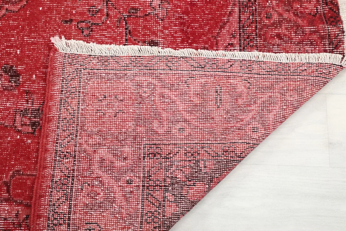 Close-up of the rug's back, showing the tight hand-knotting and foundation threads.