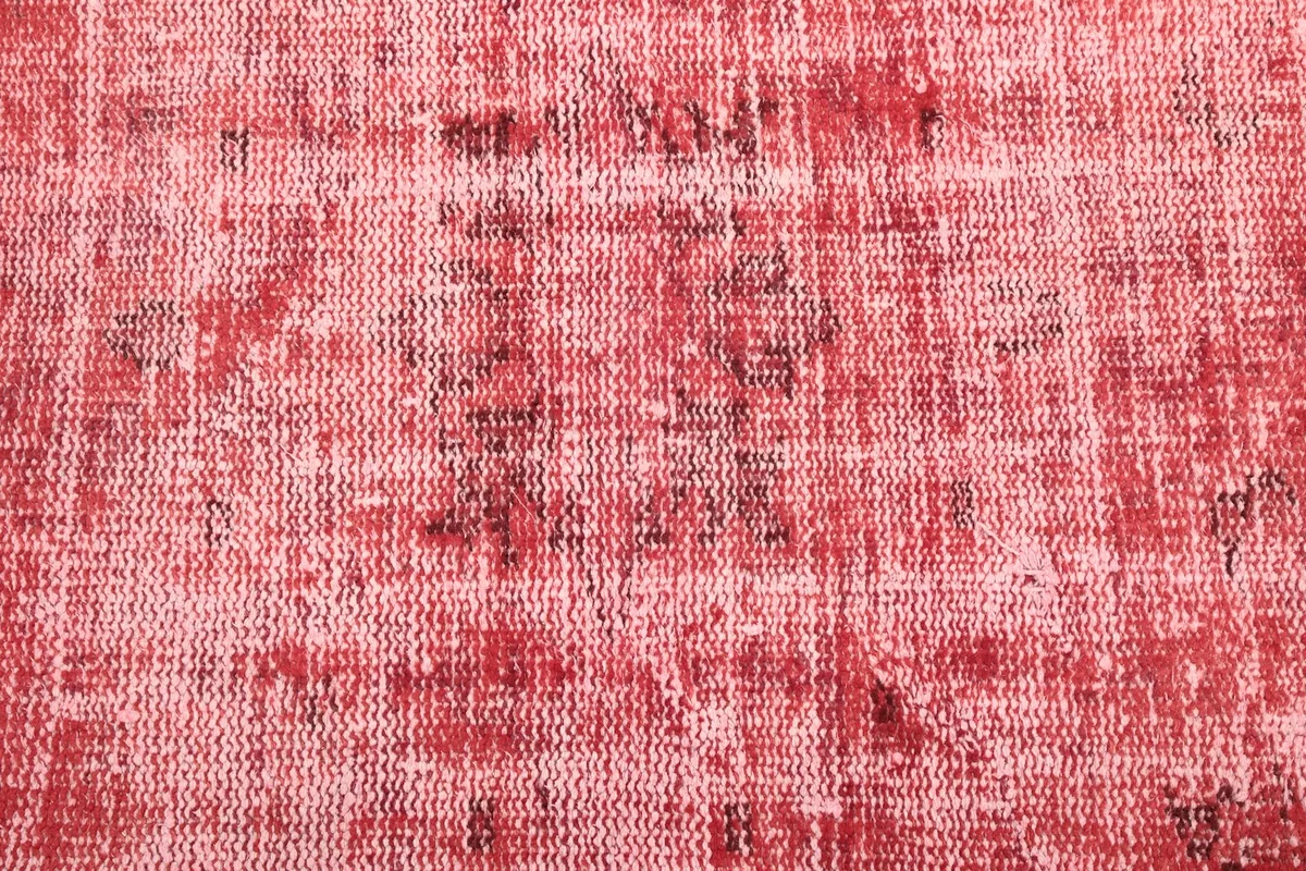 Close-up of the distressed wool pile, showing darker underlying threads