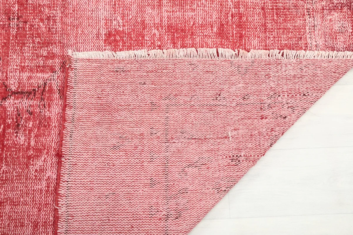 Close-up of the rug's reverse side, showing the hand-knotted cotton foundation