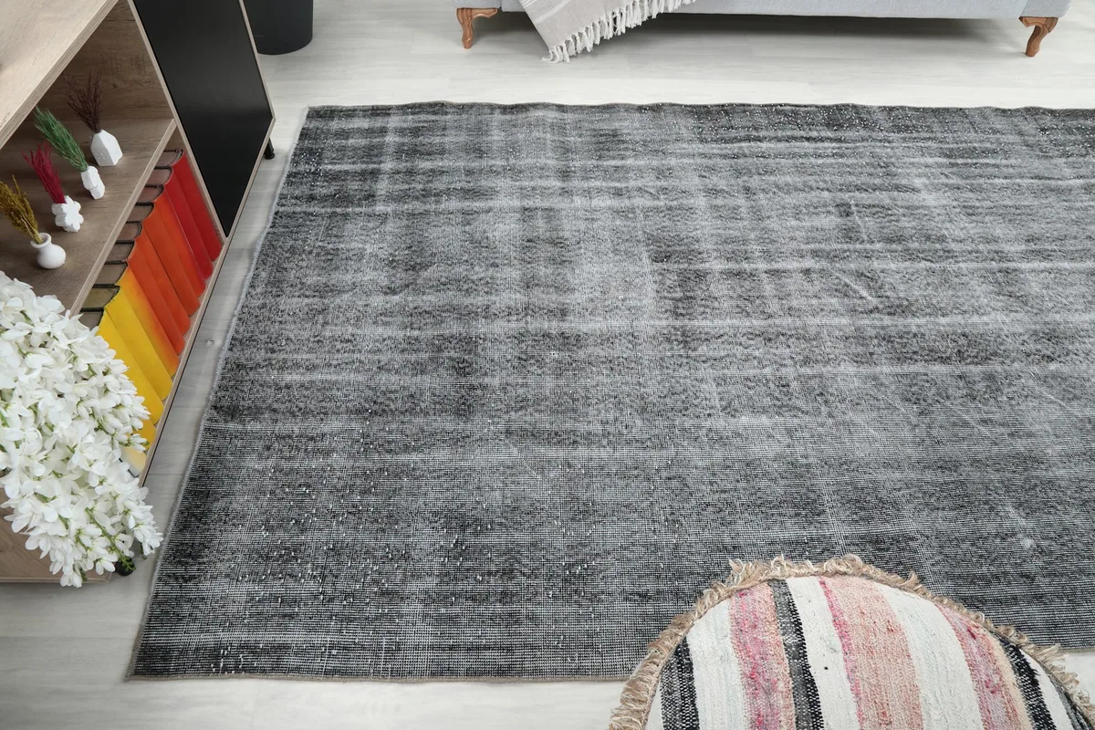 Wide-angle view of the rug, showing its placement in the room and the overall charcoal tone.