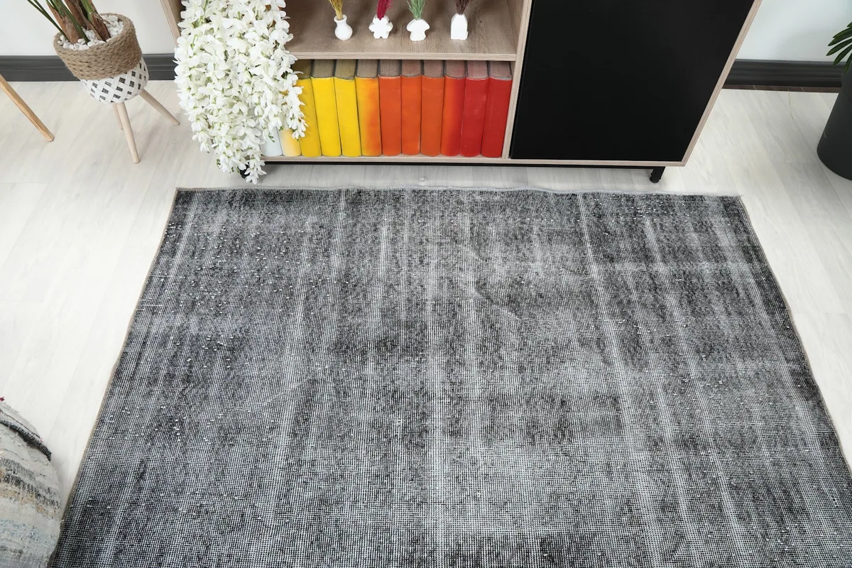 Overhead shot of the rug in a room setting, showcasing its even distressed appearance.